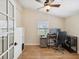 Home office with built-in desk, hardwood floors, and ceiling fan at 9913 Alavista Dr, Gibsonton, FL 33534