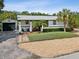 House exterior with a detached garage and fenced yard at 9913 Alavista Dr, Gibsonton, FL 33534