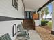 Inviting front porch with wooden stairs and comfortable adirondack chairs at 9913 Alavista Dr, Gibsonton, FL 33534