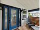 Charming front porch with blue door and wooden accents at 9913 Alavista Dr, Gibsonton, FL 33534