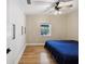 Bright bedroom featuring built-in closet and wood floors at 9913 Alavista Dr, Gibsonton, FL 33534