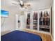 Well-organized bedroom with large walk-in closet and TV at 9913 Alavista Dr, Gibsonton, FL 33534