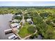 Aerial view showcasing waterfront property with lush landscaping and private dock at 9913 Alavista Dr, Gibsonton, FL 33534