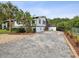Charming single story home with a gravel driveway and landscaping at 9913 Alavista Dr, Gibsonton, FL 33534