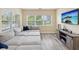 Spacious Gathering room featuring a large sectional sofa and wall-mounted TV at 9913 Alavista Dr, Gibsonton, FL 33534