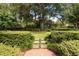 Landscaped garden with a secluded sitting area and lush greenery at 1506 S Sheridan Forest Dr, Tampa, FL 33629