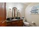 Elegant powder room with dark vanity and art at 1506 S Sheridan Forest Dr, Tampa, FL 33629