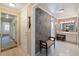 Elegant bathroom with patterned wallpaper and a vanity with a stool at 1506 S Sheridan Forest Dr, Tampa, FL 33629
