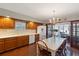 Kitchen features wood cabinets, tile floor, and breakfast nook at 1506 S Sheridan Forest Dr, Tampa, FL 33629