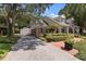 Brick house with a spacious driveway and landscaping at 1506 S Sheridan Forest Dr, Tampa, FL 33629