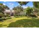 Large backyard with a grassy lawn and mature trees at 1506 S Sheridan Forest Dr, Tampa, FL 33629