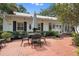 Brick patio with a table and chairs, perfect for outdoor dining at 1506 S Sheridan Forest Dr, Tampa, FL 33629