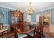 Formal dining room features striped wallpaper and chandelier at 1506 S Sheridan Forest Dr, Tampa, FL 33629