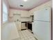 Clean kitchen featuring white cabinets and tiled floors at 401 Dorchester Pl # 58, Sun City Center, FL 33573