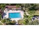 An aerial view of refreshing community pool with surrounding lounge chairs and patio area at 401 Dorchester Pl # 58, Sun City Center, FL 33573