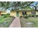 Charming yellow house with a green door and walkway at 401 Dorchester Pl # 58, Sun City Center, FL 33573