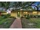 Yellow condo building with green door entrance at 401 Dorchester Pl # 58, Sun City Center, FL 33573