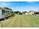 View of backyard, showcasing a grassy area and neighboring homes at 401 Dorchester Pl # 58, Sun City Center, FL 33573