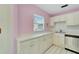 Bright kitchen features white cabinets, stainless steel appliances, and a corner sink at 401 Dorchester Pl # 58, Sun City Center, FL 33573