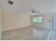 Living room with laminate flooring and large window at 401 Dorchester Pl # 58, Sun City Center, FL 33573