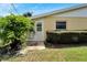 Rear view of home showing a secondary entrance and patio area at 401 Dorchester Pl # 58, Sun City Center, FL 33573