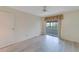 Bright bedroom featuring laminate flooring and access to a private patio at 401 Dorchester Pl # 58, Sun City Center, FL 33573