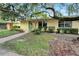 Cute yellow home with green door and landscaped yard at 401 Dorchester Pl # 58, Sun City Center, FL 33573