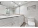 Updated bathroom with white cabinets, quartz countertop and a walk-in shower at 1655 S Highland Ave # J390, Clearwater, FL 33756