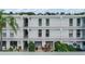 Condo building exterior with balconies and lush landscaping at 1655 S Highland Ave # J390, Clearwater, FL 33756