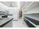 Kitchen with white cabinets, pantry and ceiling fan at 1655 S Highland Ave # J390, Clearwater, FL 33756