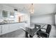 Kitchen with white cabinets and breakfast bar at 1655 S Highland Ave # J390, Clearwater, FL 33756