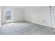 Simple bedroom with neutral carpeting and a window with natural light at 1655 S Highland Ave # J390, Clearwater, FL 33756