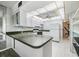 Kitchen features white cabinets and a pantry at 1655 S Highland Ave # J390, Clearwater, FL 33756