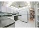 Bright kitchen with white cabinets and appliances at 1655 S Highland Ave # J390, Clearwater, FL 33756