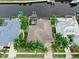 Top-down aerial shot of home showing the well manicured lawn and landscaping with direct access to the canal at 617 Islebay Dr, Apollo Beach, FL 33572