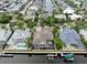 Aerial view of waterfront homes with docks and screened patios on a sunny day at 617 Islebay Dr, Apollo Beach, FL 33572