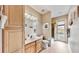 Bathroom featuring wood cabinets and access to the outdoor patio area at 617 Islebay Dr, Apollo Beach, FL 33572