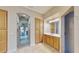 Bathroom featuring a walk-in shower, sink, vanity, and a connecting hallway to the main bedroom at 617 Islebay Dr, Apollo Beach, FL 33572