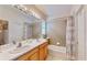 Well-lit bathroom features double sinks, neutral tile, and tub with shower combination at 617 Islebay Dr, Apollo Beach, FL 33572
