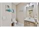 Half bath features a modern vanity, stylish mirror, and coastal themed decorations at 617 Islebay Dr, Apollo Beach, FL 33572