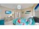 Comfortable bedroom features vibrant bedding, wall-mounted TV, and calming beach themed decor at 617 Islebay Dr, Apollo Beach, FL 33572