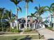 Charming single-Gathering home boasts lush landscaping, tall palms, and a welcoming front porch at 617 Islebay Dr, Apollo Beach, FL 33572