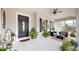 Inviting front porch features a seating area, ceiling fan, and attractive landscaping at 617 Islebay Dr, Apollo Beach, FL 33572