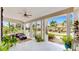 Inviting front porch features comfortable seating, ceiling fan, potted plants, and views of the lovely neighborhood street at 617 Islebay Dr, Apollo Beach, FL 33572