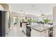 Open-concept kitchen featuring granite countertops, a large island, and modern finishes at 617 Islebay Dr, Apollo Beach, FL 33572