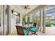 Covered lanai featuring a dining table and chairs, ceiling fan, and beautiful backyard views at 617 Islebay Dr, Apollo Beach, FL 33572