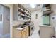 Well-organized laundry room with modern washer, dryer, ample storage, and utility sink at 617 Islebay Dr, Apollo Beach, FL 33572