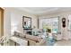 Bright living room featuring a fireplace, neutral decor, and sliding doors to a patio with outdoor seating at 617 Islebay Dr, Apollo Beach, FL 33572