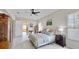 Well-lit bedroom offering a ceiling fan, stylish decor, an ensuite bath, and light walls at 617 Islebay Dr, Apollo Beach, FL 33572