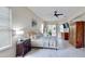 Bright bedroom featuring a ceiling fan, ensuite bath, light walls and ample natural light with stylish furnishings at 617 Islebay Dr, Apollo Beach, FL 33572